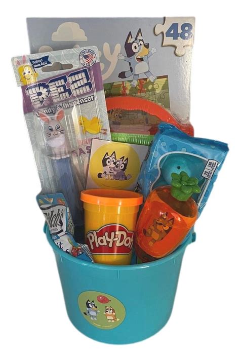 14 Piece prefilled Disney JR Bluey easter basket. This basket is wrapped in clear cellophane and topped with a large bow. This basket includes a stuffed BLUEY character doll (choose your style), a puzzle in carry tin container, sticker face sheets, Bluey Easter book (SOLD OUT_***replaced by BLUEY